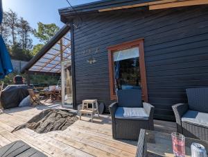 a house with two chairs and a table on a deck at Rasteplassen in Stordalen +20 photos