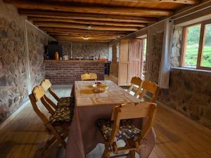 a dining room with a table and some chairs at Casa Rumiwillka in Urubamba