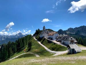 a village on a hill with a church on it at Bosco Verde in Tarvisio