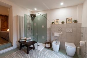 a bathroom with a shower and a toilet and a sink at RoncoBèrtolo R&B in Loiano