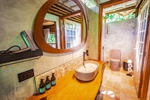 a bathroom with a sink and a mirror at Banana Bamboo Ecolodge in Ubatuba +49 photos