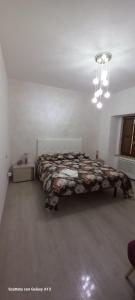 a bedroom with a large bed in a white room at Kylix Home in Campobasso