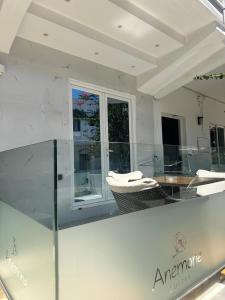 a glass counter in a room with a table and chairs at Anemone Suites in Georgioupolis +15 photos