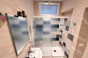 a bathroom with a shower and a sink and a mirror at Sant'Agostino in Pizzo +25 photos