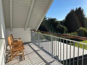 a porch with a rocking chair on a balcony at Urlaub-Im-Erletal in Schleusingen