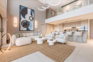 a living room with a white couch and a kitchen at Villa Erifyli in Aghia Marina