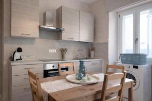 a kitchen with a table and chairs and a sink at Sant'Agostino in Pizzo