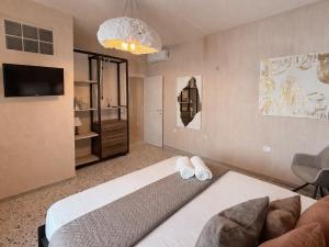 a bedroom with a bed and a couch and a tv at Sant'Agostino in Pizzo