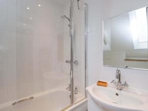 a white bathroom with a shower and a sink at Stanbridge Cottage in Malmesbury +33 photos