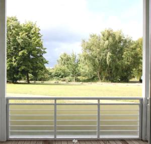 a view of a field from the balcony of a house at DUENENROSE App Nr 03 max 3 Pers in Dierhagen