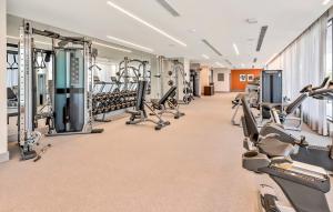 a gym with rows of treadmills and machines at Bonito doral in Miami