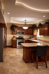 a large kitchen with wooden cabinets and a counter top at Arroyos del Paraíso Residencial Suite B in Manuel F. Martínez