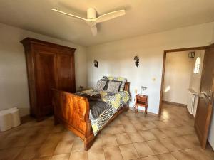 a bedroom with a bed and a ceiling fan at Villa Les Oliviers in Orange