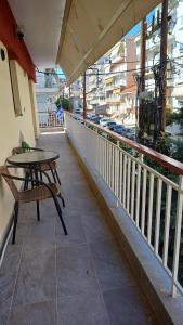 a table and chair on a balcony with a view at Capital Apartment kilkis in Kilkis