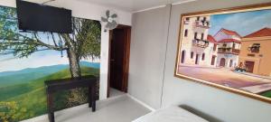 a room with a painting on the wall and a couch at Casa hotel villadiana in Armenia