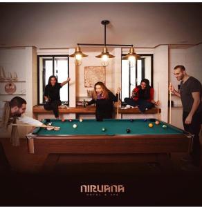 a group of people sitting around a pool table at Laklouk Village Vacances in Jbeil +8 photos