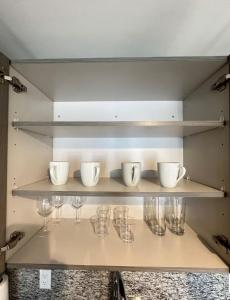 a shelf with glasses and cups on it at Bonito doral in Miami