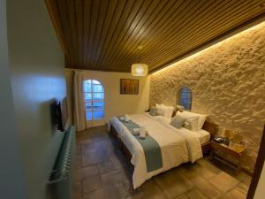 a bedroom with a large bed and a window at Laklouk Village Vacances in Jbeil