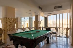 a pool table in a large room with windows at Sunny Days El Palacio Resort & Spa in Hurghada