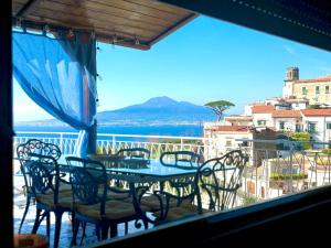 a view of a balcony with a table and chairs at The Dreamer's Terrace in Vico Equense