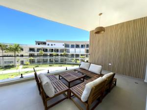 a living room with a table and chairs and a large window at Beachfront Paradise - Huge Pool, Ocean View & Surf in Cabarete