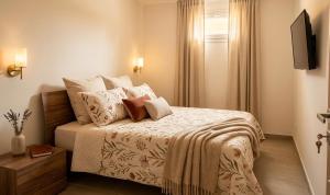 a bedroom with a bed with white sheets and pillows at Casa Asprigna in Ficarazzi