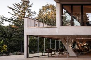 a house with glass doors and a balcony at Valle Benedetta Retreat Center in Livorno