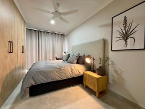 a bedroom with a bed and a ceiling fan at Executive Suite South Fork in Kimberley