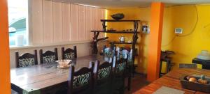 a dining room with a wooden table and chairs at Casa hotel villadiana in Armenia