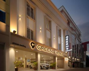 a hotel with a sign that reads greensvenuevenue at Greens Venue in Chennai