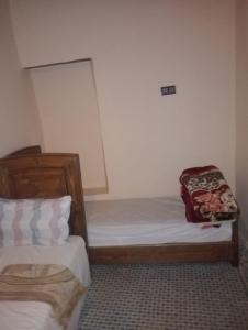 a bedroom with two twin beds in a room at Esc 3 in Fez +3 photos