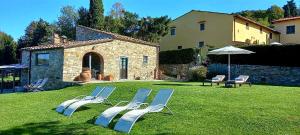 a group of blue and white chairs on a lawn at Il Poggio al Sole in Fiesole
