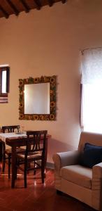 a living room with a table and a couch and a mirror at Il Poggio al Sole in Fiesole +29 photos