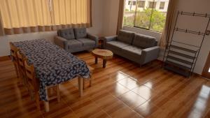 a living room with a table and a couch at Depa Urubamba in Urubamba +19 photos