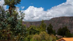 a view of a mountain range with trees and buildings at Depa Urubamba in Urubamba