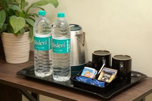 two bottles of water on a tray on a table at Greens Venue in Chennai