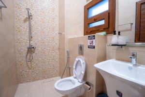 a bathroom with a toilet and a sink and a shower at Bait mutirah guesthouse in Muscat +35 photos