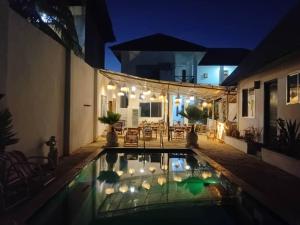 a house with a swimming pool at night at POLE-INN VILLA Nungwi Zanzibar in Nungwi