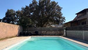 a swimming pool in the yard of a house at Villa Bella Vita in Biguglia