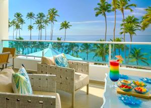 a resort balcony with a view of the ocean at Marbella Juan Dolio Beachfront in Juan Dolio