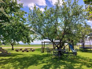 a park with a playground and picnic tables and a tree at Wagnerhof in Au am Inn