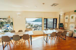 a large dining room with a table and chairs at Guesthouse All you need - All rooms have an ocean view! in Shimoda
