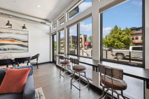 a dining room with a table and chairs and windows at Downtown Gem in Whitefish