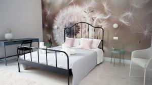 a bedroom with a bed with a flower wall at Luxury Suite ATHENA - MINERVA in Reggio di Calabria