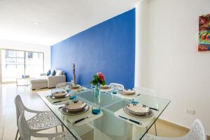 a dining room with a glass table and chairs at Ph and apartments riviera Maya in Playa del Carmen