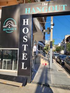 a sign for the hangout in front of a building at The HANGOUT Hostel in Sarandë