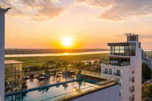 a view of the sunset from the balcony of a building at Aaron Riverview Hotel in Vientiane