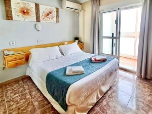 a bedroom with a bed with two towels on it at Hotel Alaska in San Pedro del Pinatar +102 photos