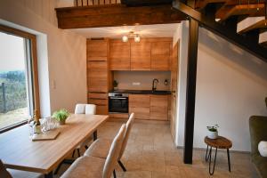 a kitchen and dining room with a wooden table at Wohlfühl Apartments am Hof Rapotz in Leutschach