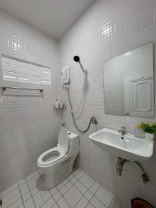 a bathroom with a toilet and a sink at AN Airport Guesthouse in Nai Yang Beach